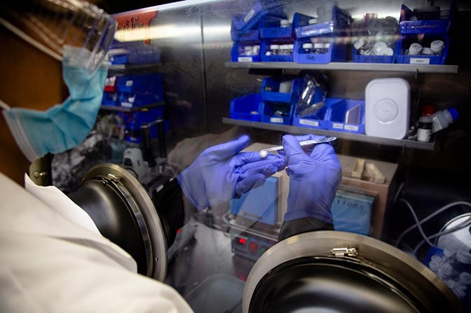 Michael Wang, materials science and engineering Ph.D. candidate, uses a glove box to inspect a lithium metal battery cell in a lab in the Michigan Memorial Phoenix Project building at the University of Michigan in Ann Arbor, Mich. on October 19, 2020.