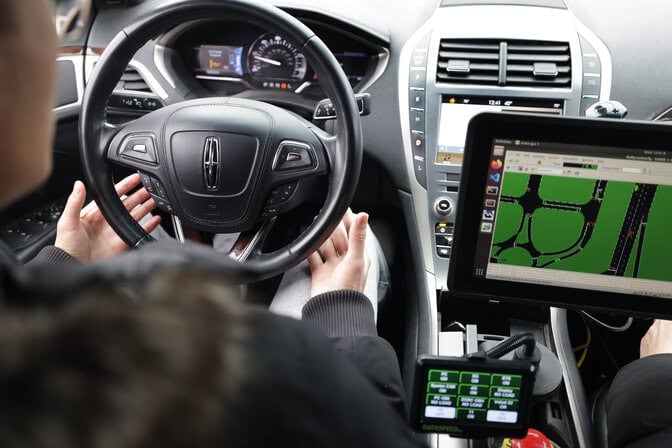 A driver sits inside an Mcity test vehicle