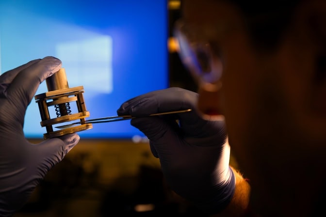 A researchers adjusts his water desalination device