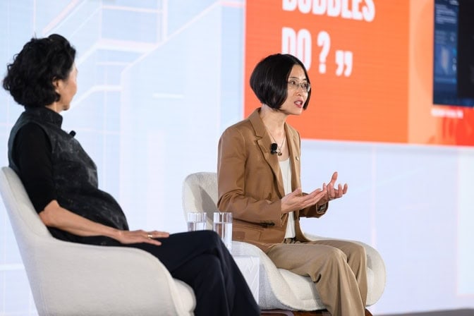 Zhen Xu in discussion during a panel.